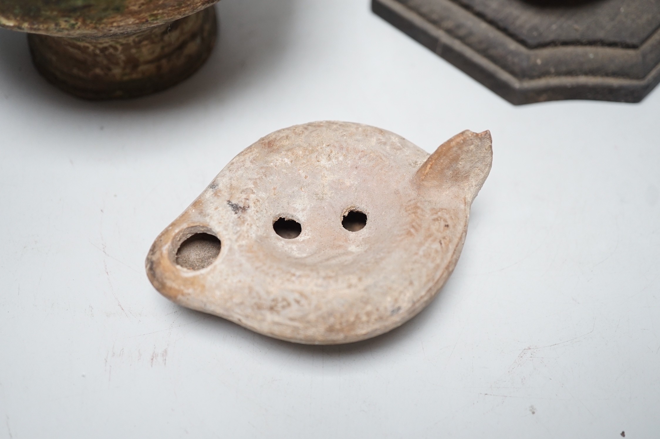 A Roman green glazed vessel, 13 cm wide and a pottery oil lamp, with letter of provenance dated 1942 stating that they were excavated 50-60 years previously during excavations for Lincoln’s Inn New chapel London and a se